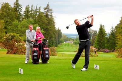 De Vere Club Ambassador Freddie Flintoff tees off watched by Harry Redknapp and Sophie Horn